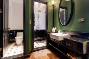 a bathroom with a sink and a toilet and a mirror at Brilliant Jade Suites in Hanoi +68 photos