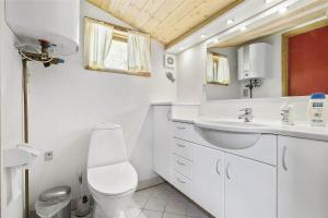 a white bathroom with a toilet and a sink at 13318-Asnaes-Lindevej-10 in Asnæs