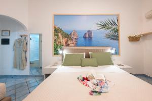 a bedroom with a bed with a large painting on the wall at Sharon House in Amalfi