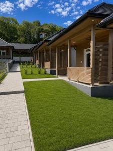 a yard with green grass next to a house at V44 Resort in Visegrád +4 photos