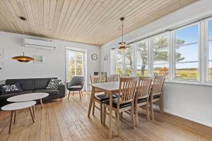 a living room with a table and chairs at 0163-Romo-Havnebyvej-5 in Høm