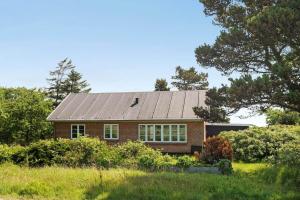 a red brick house with a solar roof at 0163-Romo-Havnebyvej-5 in Høm
