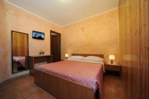 Posteľ alebo postele v izbe v ubytovaní Albergo Pensione Paola