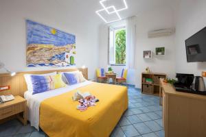a bedroom with a yellow bed with toys on it at Sharon House in Amalfi