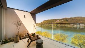 a room with a balcony with a view of a river at Ripple Boutique Hotel in Yangpyeong