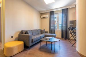 a living room with a couch and a table at Premium Rezidans Otel in Antalya