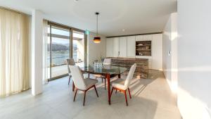 a dining room with a table and chairs and a kitchen at Ripple Boutique Hotel in Yangpyeong