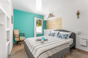 a bedroom with a large bed with a blue wall at Casa S’Arraval in Mahón +9 photos