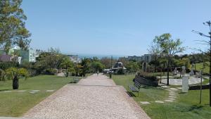 a walkway in a park with benches and trees at Oeiras Central, near Beach & Public Transport in Oeiras