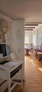 a room with a piano and a clock on the wall at Pension Seeschlösschen in Mölln