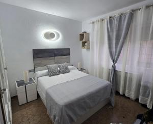 a bedroom with a bed and a large window at Villa Flores in Alicante +31 photos