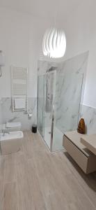 a white bathroom with a toilet and a sink at Trivia Rent in Reggio di Calabria