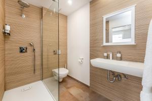 a bathroom with a shower and a toilet and a sink at Casa S’Arraval in Mahón