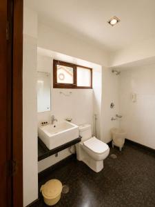 a bathroom with a white toilet and a sink at May Fair in Mandi