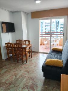 a living room with a couch and a table and chairs at Edificio Mirasierra in Oropesa del Mar