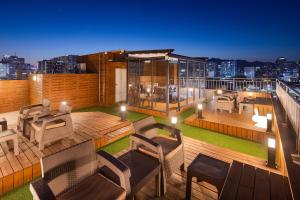 a rooftop deck of a building with a view of the city at 스태이링크 Staylink in Seoul
