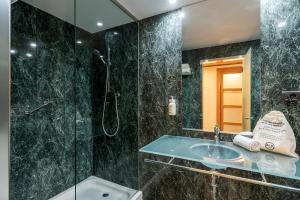 a bathroom with a shower and a sink at B&B HOTEL Castellón in Castellón de la Plana +39 photos