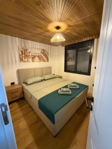 a bedroom with a bed with two towels on it at Buna riverfront in Ulcinj