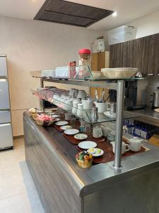 a kitchen with a counter with dishes on it at Hôtel Matous in Tunis