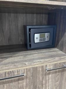a microwave sitting on top of a wooden cabinet at Hôtel Matous in Tunis