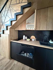 a kitchen with a sink and a staircase at Buna riverfront in Ulcinj