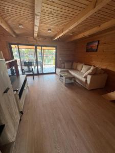 a living room with a couch and a table at Ada Bojana Kucica in Ulcinj