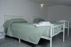 a bedroom with a green bed and a table at Apollinare's House in Classe