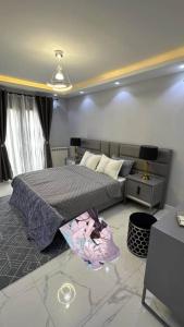a bedroom with a bed and a nightstand at ابراج الصفوه الذهبيه 1 in Cairo