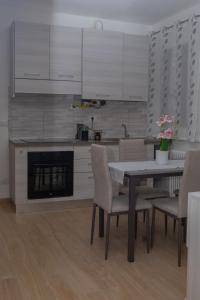 a kitchen with a table and chairs and a fireplace at Apollinare's House in Classe +9 photos