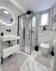 a white bathroom with a sink and a toilet at ابراج الصفوه الذهبيه 1 in Cairo