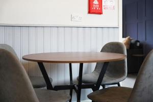 a wooden table and chairs in a room at Work Friendly 3 Bed House with Sofa Beds that Sleeps 7 in Fishburn