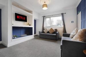 a living room with a couch and a tv at Work Friendly 3 Bed House with Sofa Beds that Sleeps 7 in Fishburn +42 photos