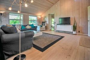 a living room with a couch and a tv at 11806-Nykobing-Sj-Klintegarden-1 in Klint
