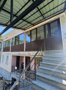 an external view of a building with stairs and windows at Bato's Vacation House in Gonio