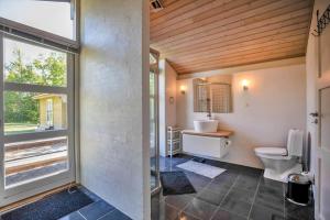 a bathroom with a toilet and a sink and a window at 11806-Nykobing-Sj-Klintegarden-1 in Klint +27 photos