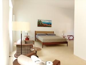 a bedroom with a bed and a couch at Dimora Villa Serena Porto Selvaggio Gallipoli in Gallipoli