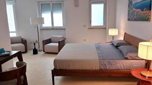 a bedroom with a bed and a couch and a chair at Dimora Villa Serena Porto Selvaggio Gallipoli in Gallipoli +35 photos