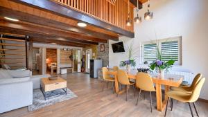 a dining room and living room with a table and chairs at Villa Exclusive by Villas Guide in Lepoglava