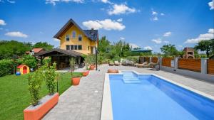 a backyard with a swimming pool and a house at Villa Exclusive by Villas Guide in Lepoglava