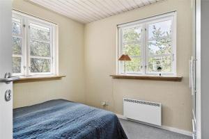 a bedroom with two windows and a bed at LF584-Hurup-Thy-Haettemagevej-4 in Sindrup