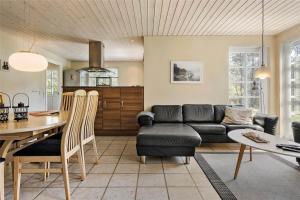 a living room with a couch and a table at LF584-Hurup-Thy-Haettemagevej-4 in Sindrup