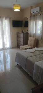 a bedroom with a bed and a dresser at ARGOSTOLI sunset in Argostoli