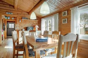 a dining room with a wooden table and chairs at LF609-Hurup-Thy-Bakkesiden-9 in Doverodde +25 photos