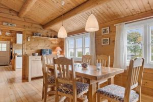 a kitchen and dining room with a table and chairs at LF609-Hurup-Thy-Bakkesiden-9 in Doverodde