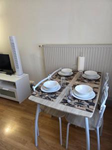 a table with plates and glasses on top of it at Spacieux studio prestige in Bischheim +12 photos