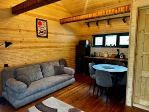 a living room with a couch and a table at Uno Cottage Kazbegi in Kazbegi