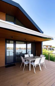 a patio with a table and chairs on a deck at Buna riverfront in Ulcinj