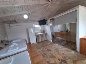 a kitchen with a white refrigerator and a counter at White house in Donji Štoj