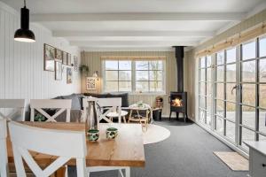 a living room with a table and a fireplace at LF622-Hurup-Bakkesiden-22 in Hurup