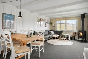 a living room with a table and a couch at LF622-Hurup-Bakkesiden-22 in Hurup +15 photos